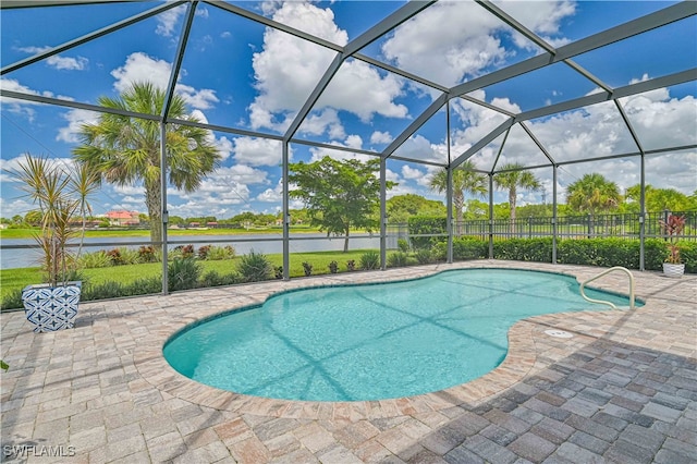 view of pool featuring a water view, a lanai, and a patio area