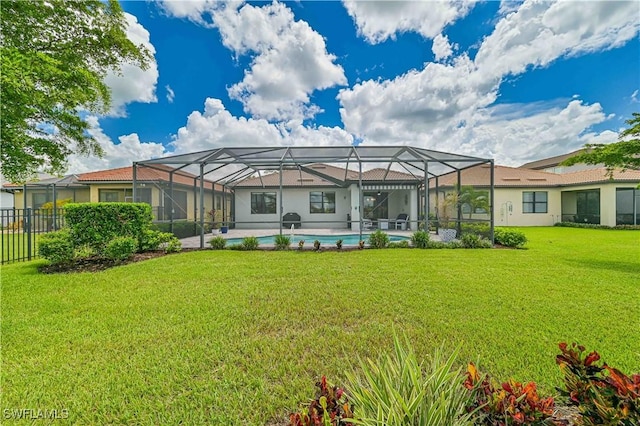 rear view of house with a lanai, a fenced in pool, and a yard