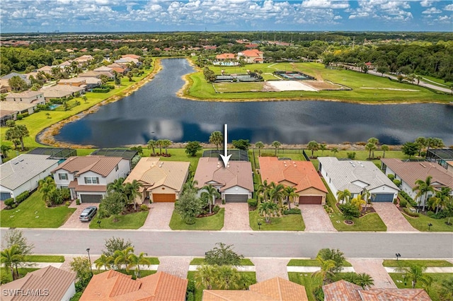 birds eye view of property with a water view