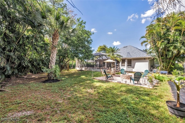 view of yard with a patio and a lanai