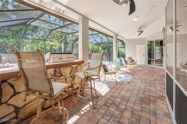 sunroom / solarium featuring ceiling fan and lofted ceiling