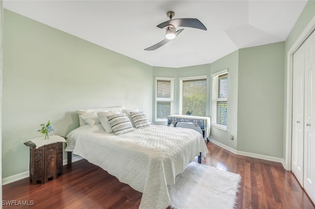 bedroom featuring dark wood-type flooring, a closet, and ceiling fan