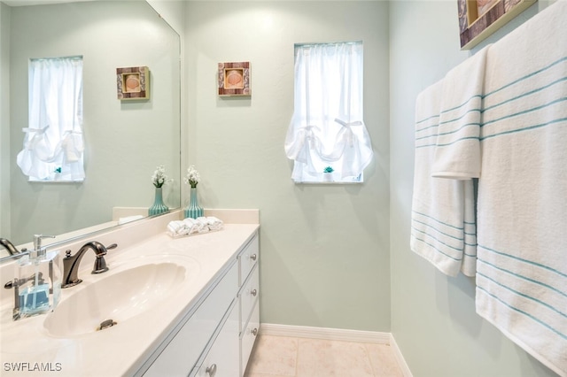 bathroom with vanity, a wealth of natural light, and tile patterned floors