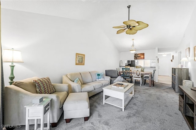 carpeted living room featuring ceiling fan and high vaulted ceiling