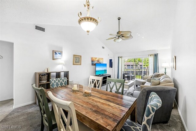 tiled dining area featuring ceiling fan and high vaulted ceiling