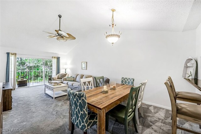 dining space with ceiling fan, a textured ceiling, carpet floors, and lofted ceiling