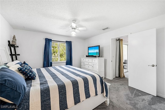 bedroom featuring ceiling fan, carpet, and a textured ceiling