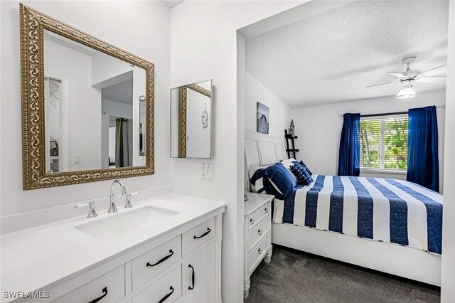 interior space with ceiling fan, sink, and a textured ceiling