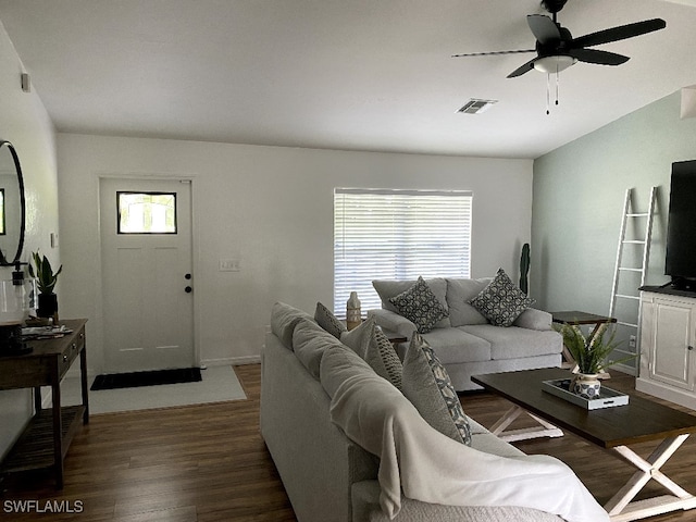 living room featuring ceiling fan, hardwood / wood-style floors, and vaulted ceiling