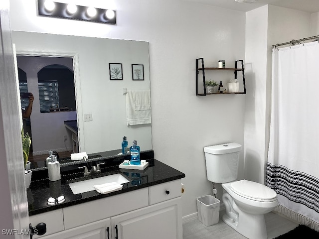 bathroom with tile patterned floors, toilet, and vanity