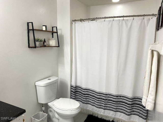 bathroom featuring toilet and vanity