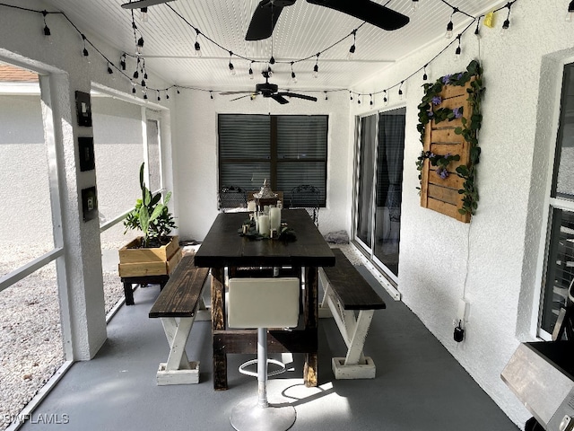 sunroom / solarium with ceiling fan and rail lighting