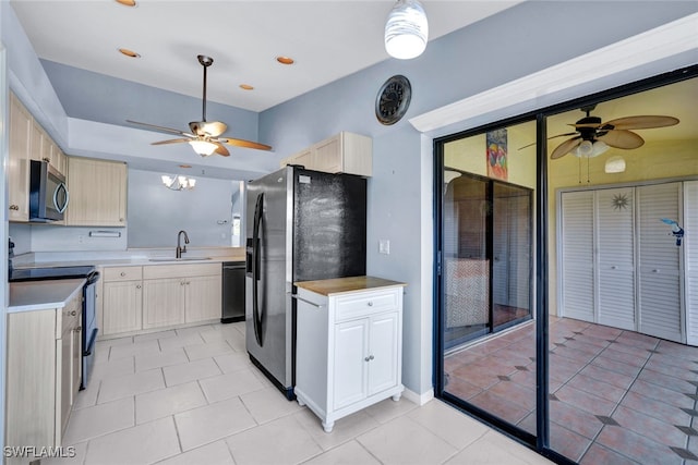 kitchen with stainless steel appliances, light tile patterned flooring, sink, and light brown cabinets