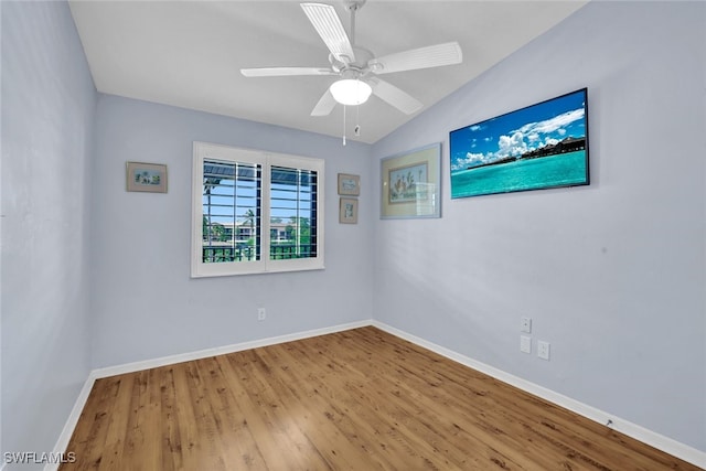 unfurnished room with ceiling fan, vaulted ceiling, and wood-type flooring