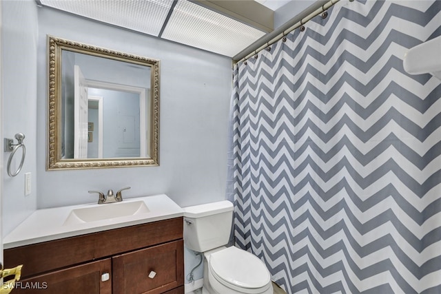 bathroom featuring vanity, toilet, and a shower with shower curtain