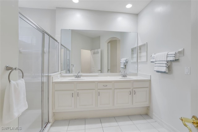 full bath with double vanity, a sink, and a shower stall