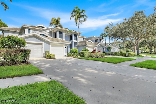 view of property with stucco siding, concrete driveway, a garage, a residential view, and a tiled roof