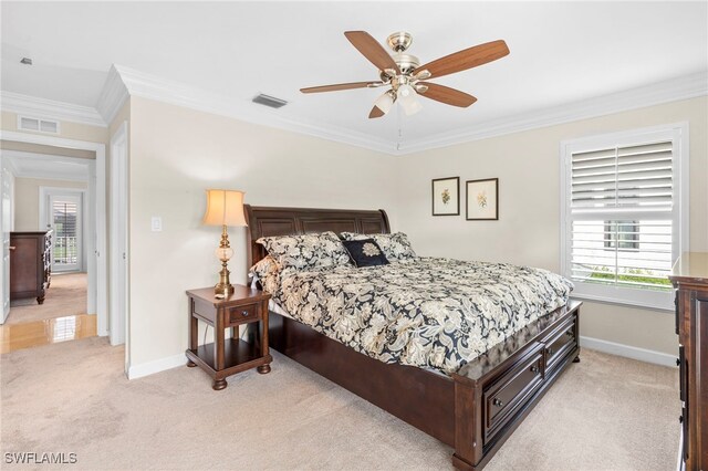 bedroom with ceiling fan, crown molding, and light carpet