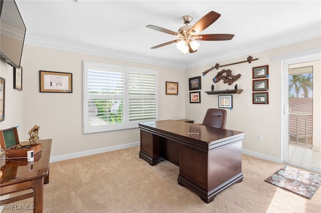 home office featuring light carpet, ceiling fan, baseboards, and crown molding