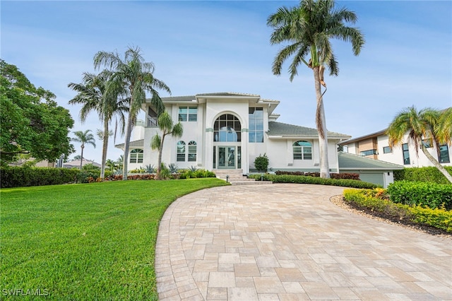 mediterranean / spanish house featuring a front lawn