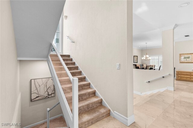 staircase with tile patterned flooring and a chandelier