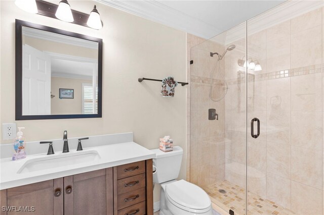 bathroom with ornamental molding, vanity, walk in shower, and toilet