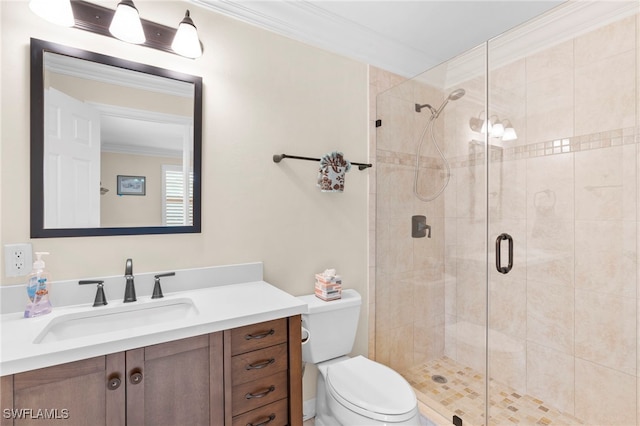 bathroom featuring toilet, a shower stall, ornamental molding, and vanity