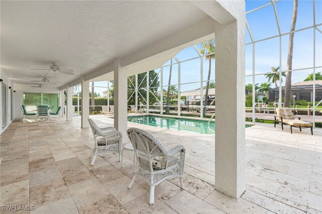 view of swimming pool featuring ceiling fan and a patio