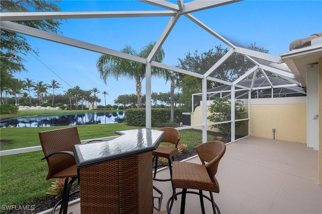 sunroom / solarium featuring a water view