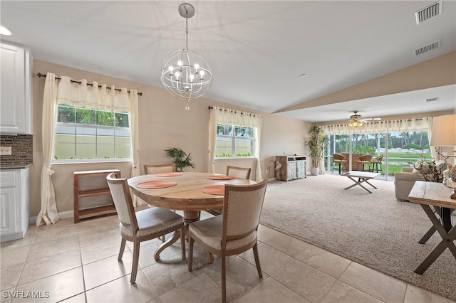 dining area featuring lofted ceiling, visible vents, plenty of natural light, and light carpet