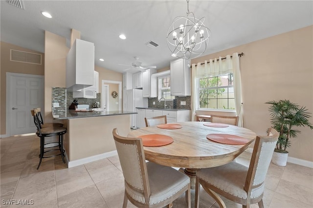 dining area with visible vents, vaulted ceiling, and baseboards