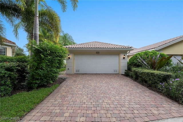 garage featuring decorative driveway