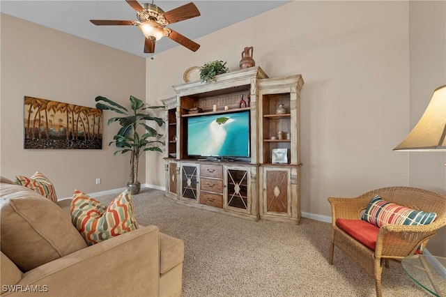 carpeted living room featuring baseboards and a ceiling fan