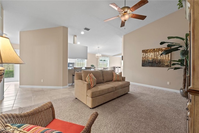 living area featuring visible vents, vaulted ceiling, baseboards, and ceiling fan with notable chandelier