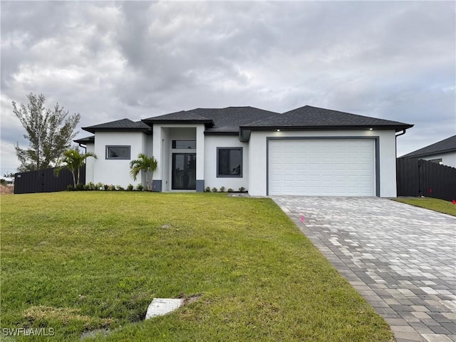 view of front of house featuring a garage and a front lawn