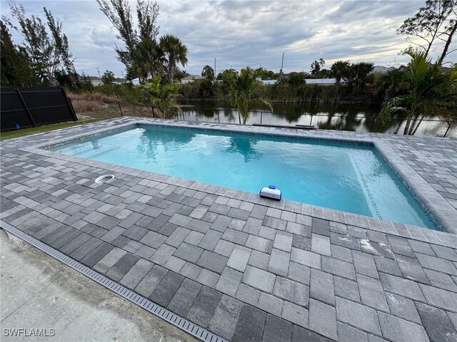 view of pool with a water view