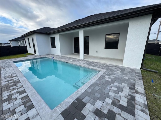 3543 NE 14th Pl, Cape Coral, FL 33909 - rear view of property featuring a patio, stucco siding, and roof with shingles