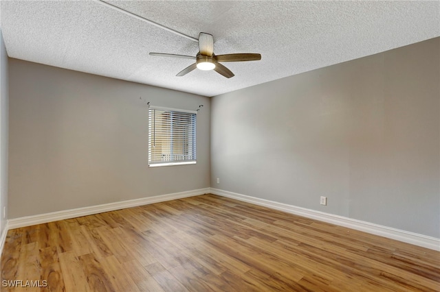 empty room featuring a textured ceiling, light hardwood / wood-style flooring, and ceiling fan