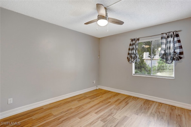 unfurnished room with ceiling fan, light hardwood / wood-style flooring, and a textured ceiling