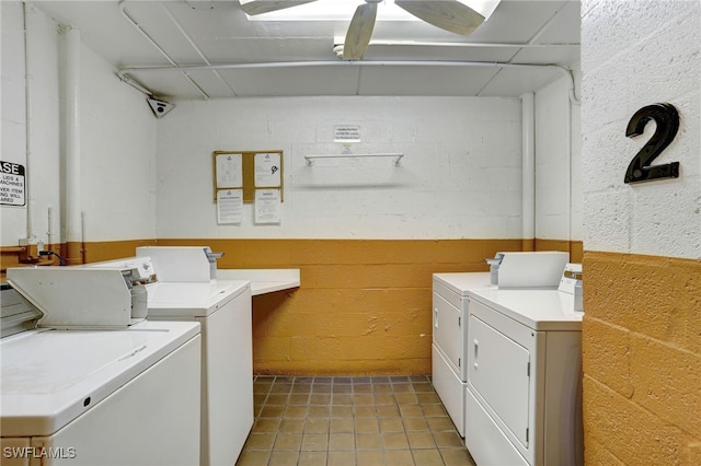 clothes washing area with ceiling fan, light tile patterned floors, and washing machine and clothes dryer