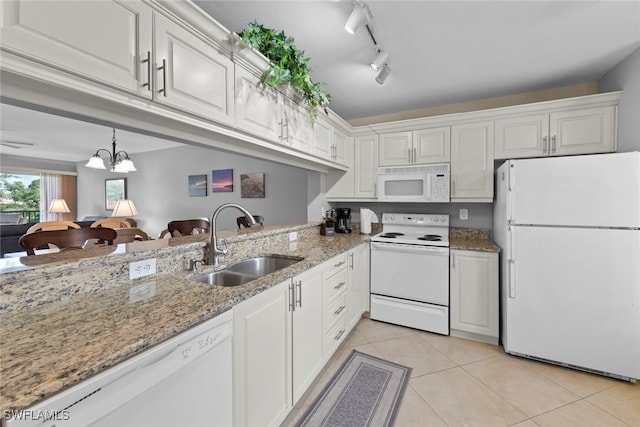 kitchen featuring sink, rail lighting, white cabinetry, and white appliances