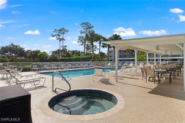 view of swimming pool with a hot tub and a patio area