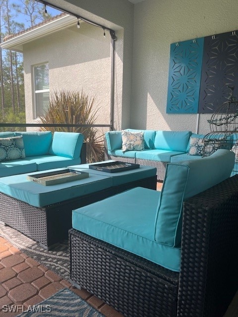 view of patio featuring an outdoor living space with a fire pit