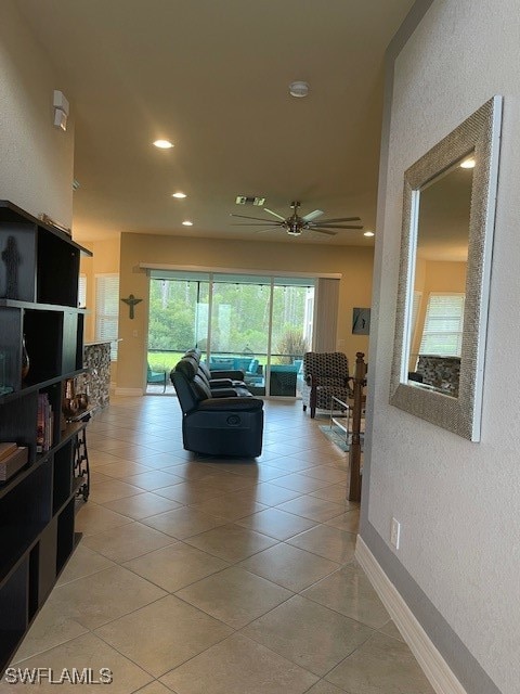 tiled living room featuring ceiling fan