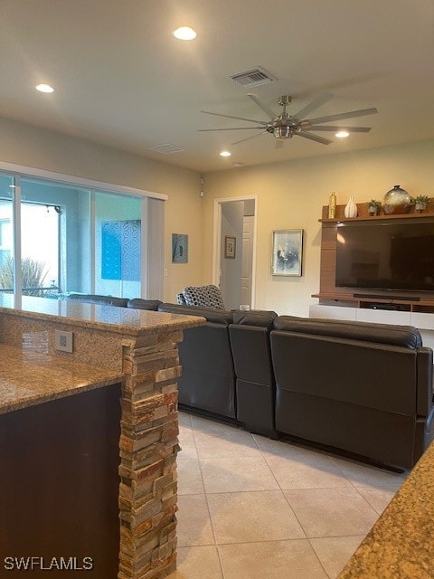 living room with ceiling fan and light tile patterned flooring