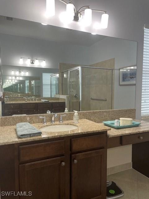 full bathroom with vanity, a shower stall, visible vents, and tile patterned floors