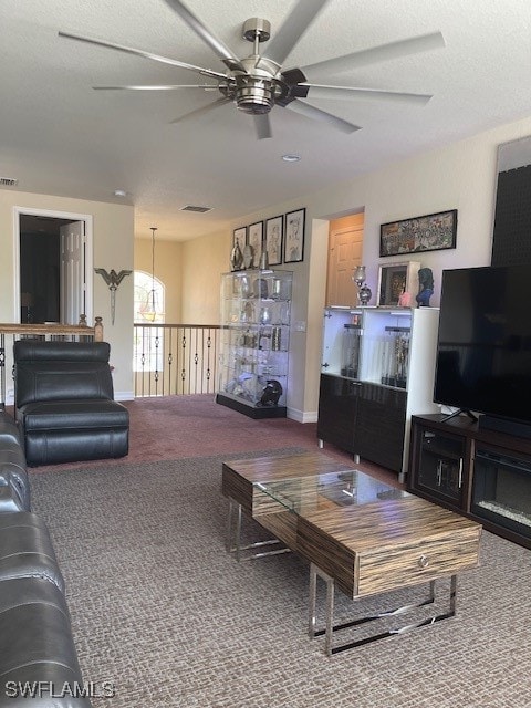 carpeted living room featuring ceiling fan