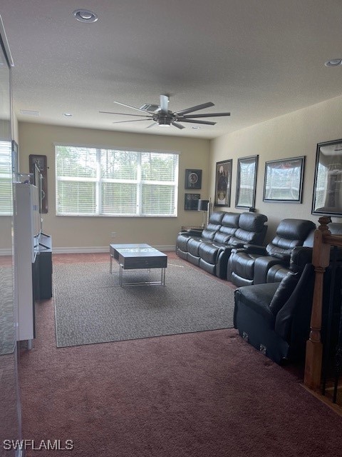 carpeted living room featuring ceiling fan