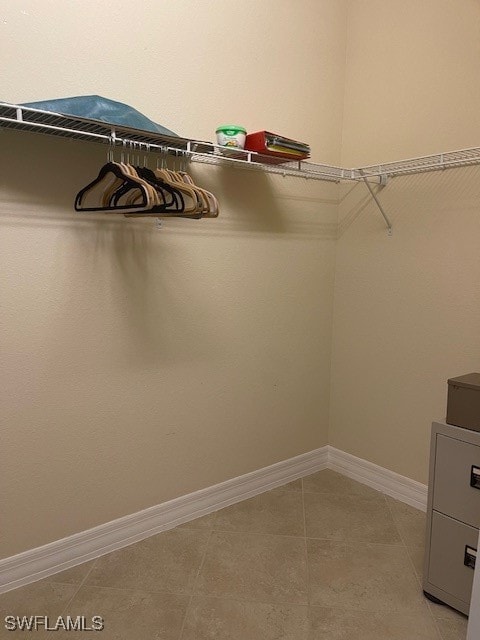 spacious closet with light tile patterned floors