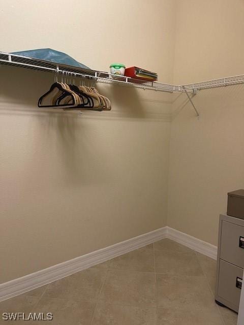 spacious closet featuring light tile patterned flooring